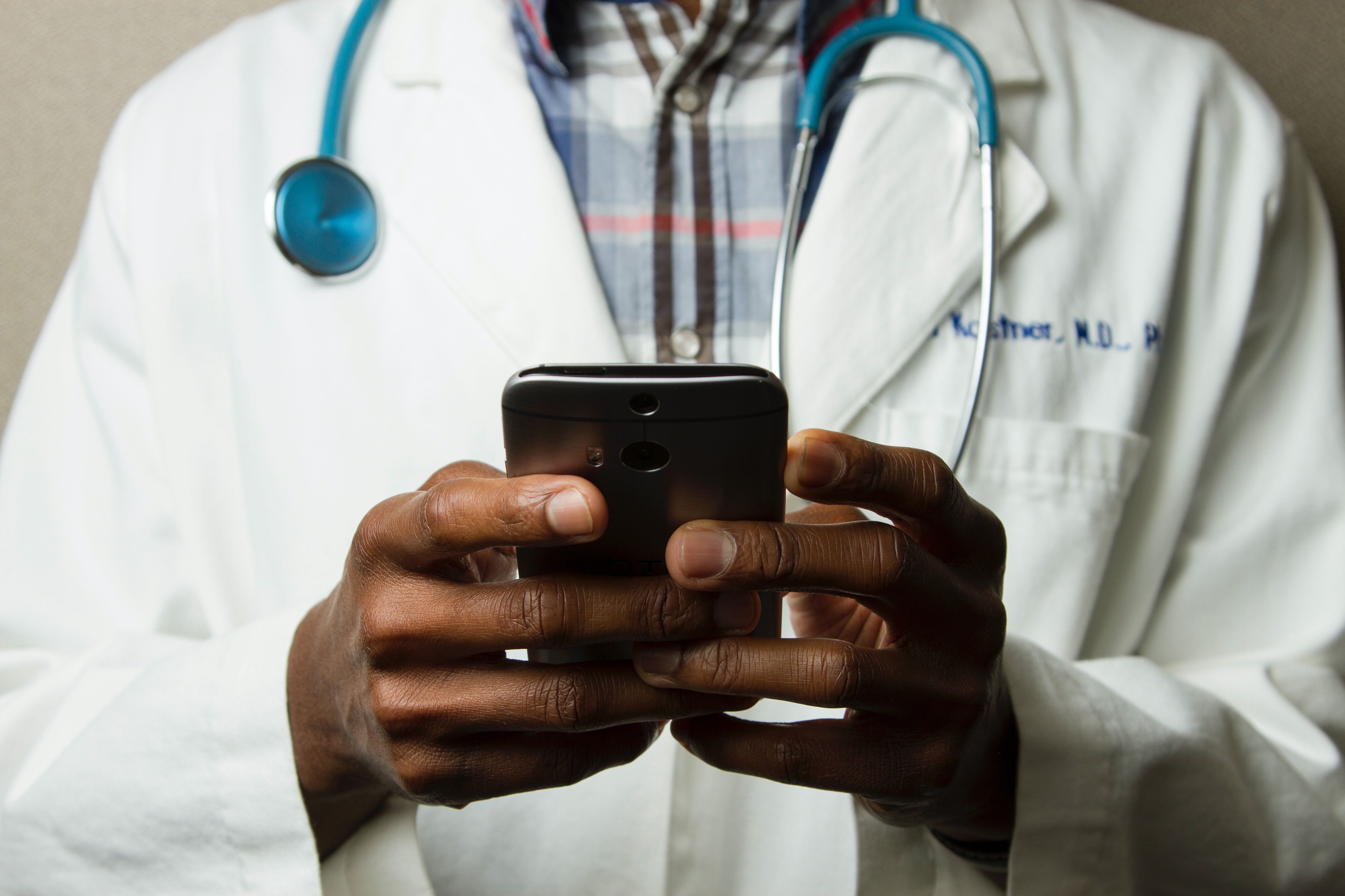 Arzt hält Smartphone in der Hand Arzt hält Smartphone in der Hand